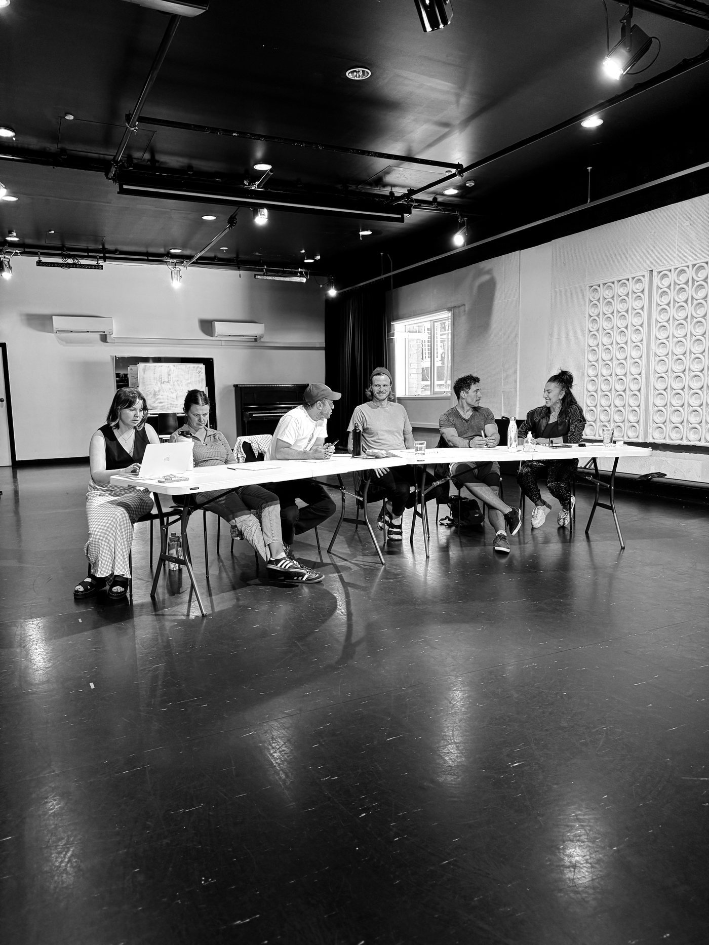 The Collegiality company in a script reading around a long table