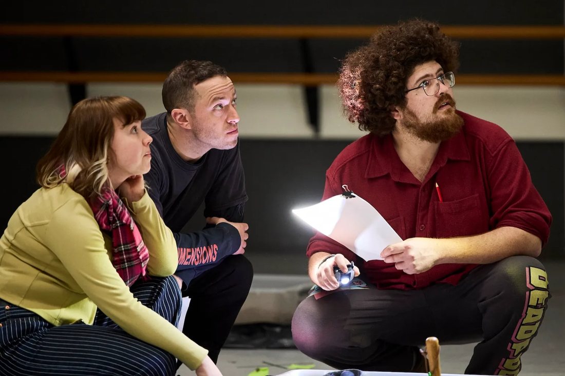 The Dig rehearsal — the company crouched around a discovery