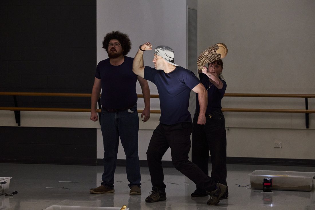 The Dig rehearsal — a strongman moment with a cardboard trilobite crown