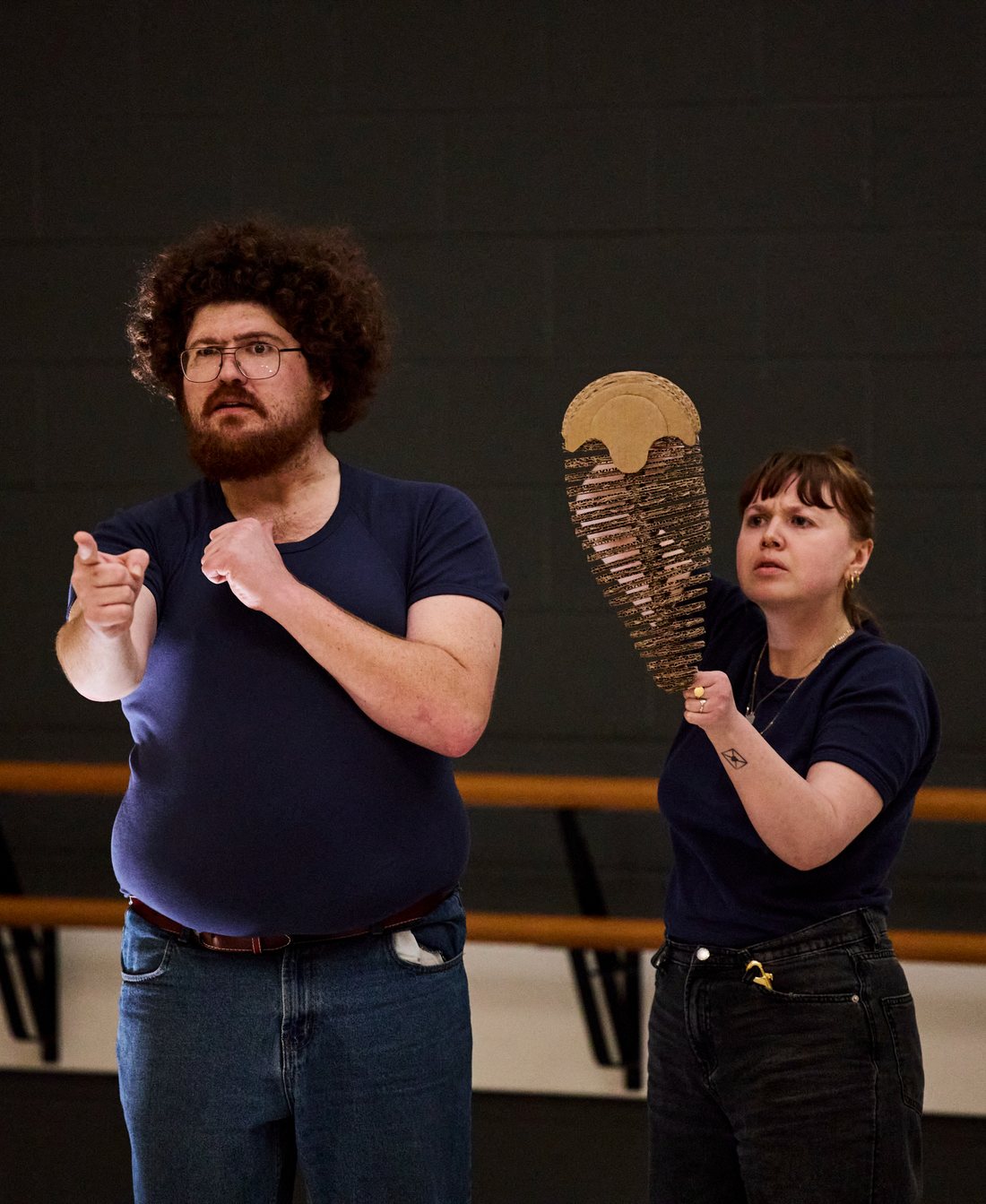 The Dig in rehearsal — Fred points down the road while a trilobite watches on